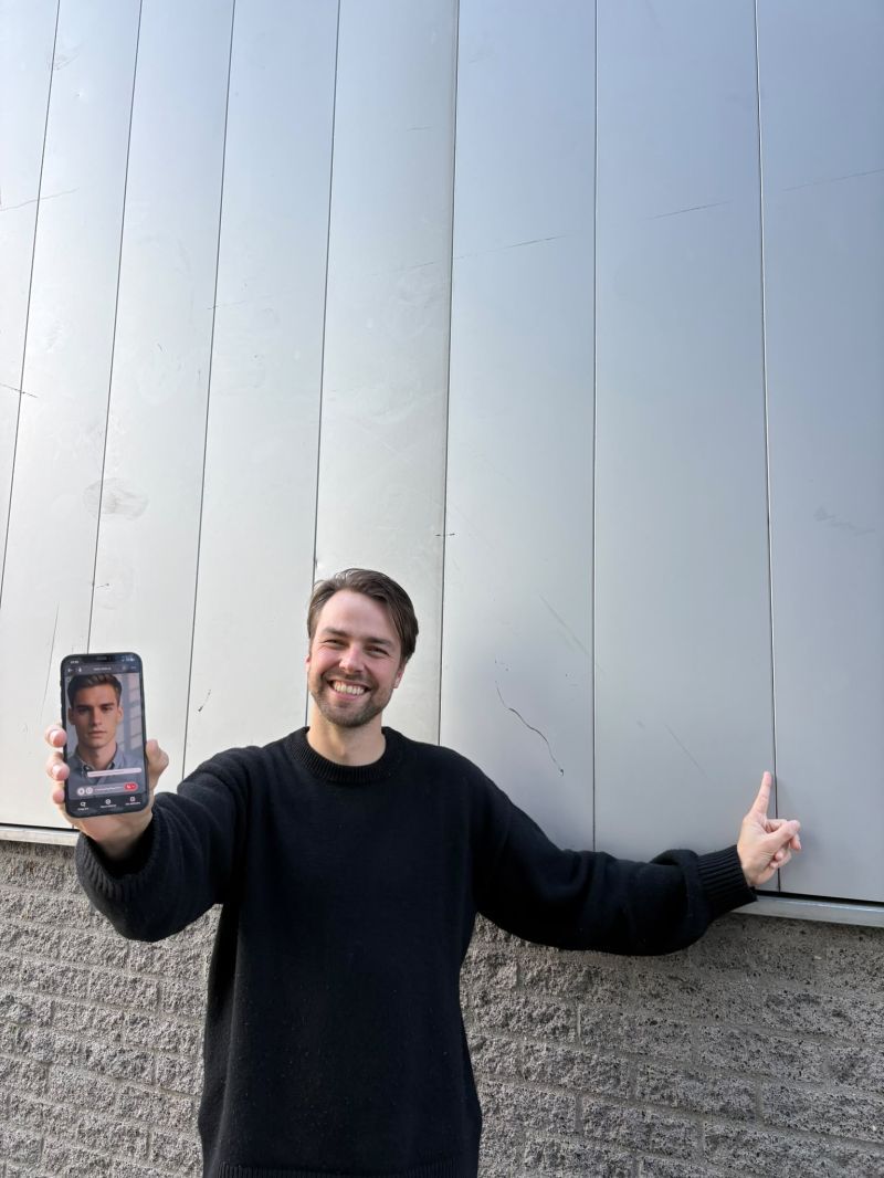 Wybren Bosma next to a data centre, holding a phone running a Meta-Skills avatar
