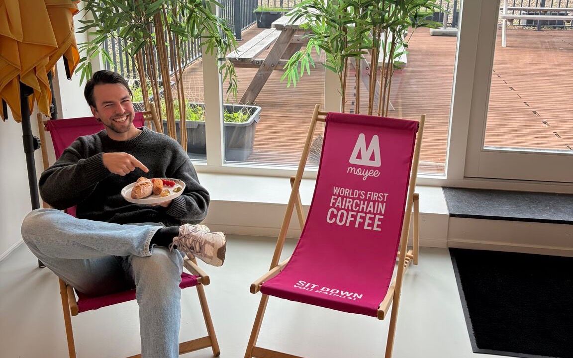 Wybren Bosma in a deckchair, pointing at a plate of broodjes croquette